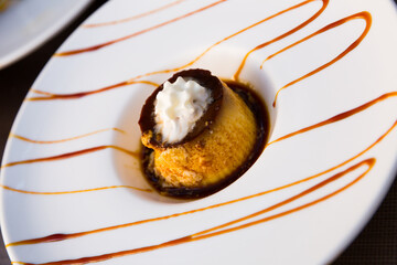 Fototapeta premium Popular Spanish custard dessert flan with layer of caramel sauce and whipped cream