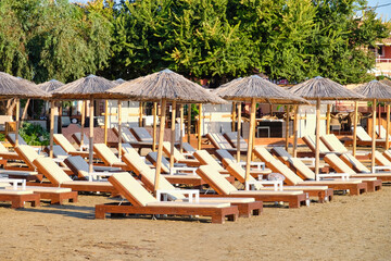 Sun loungers and beach umbrellas at sea resort