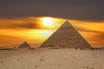 The Giza pyramids from the backside, a street leading to the pyramids