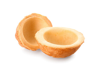 Halves of tasty walnut shaped cookies on white background