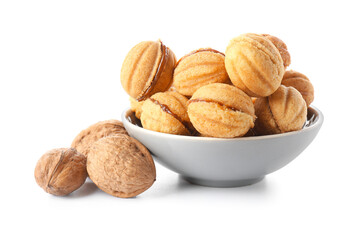 Bowl of tasty walnut shaped cookies with boiled condensed milk isolated on white background