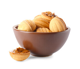 Bowl of tasty walnut shaped cookies with boiled condensed milk on white background