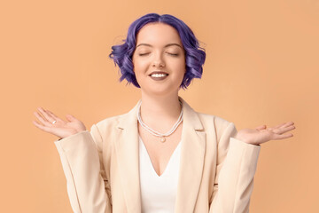 Beautiful young woman with violet hair on color background. Very Peri - color of year 2022