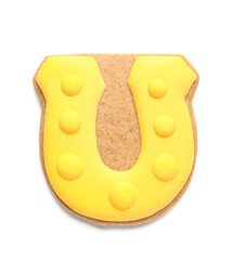 Tasty gingerbread cookie in shape of horseshoe for St. Patrick's Day celebration isolated on white background