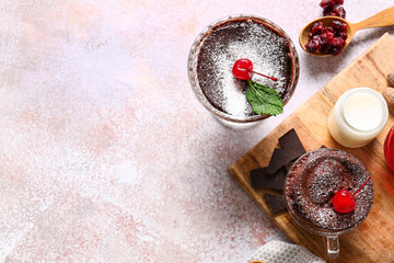 Glass bowl and cup with tasty chocolate brownie on light background