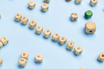 Cubes with word MENOPAUSE on blue background