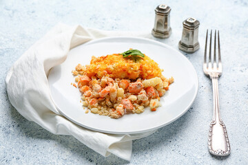 Plate with tasty English fish pie on light background