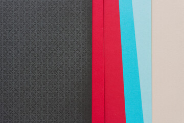 gray, red, and blue paper background (top down view) with blank space