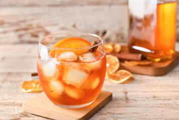 Glass of tasty Old Fashioned Cocktail on white wooden background