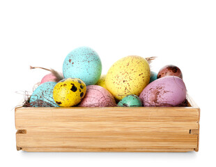 Wooden box with colorful Easter eggs on white background