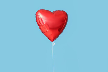 Beautiful heart-shaped balloon for Valentine's Day celebration on blue background