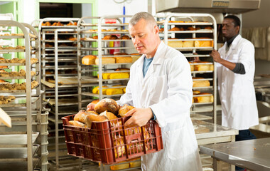 Baker sorts finished products at the bakery. High quality photo