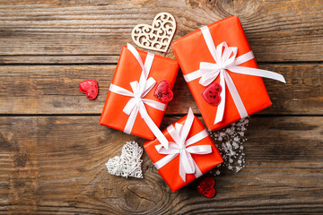 Gifts with decorative hearts on wooden background. Valentine's Day celebration