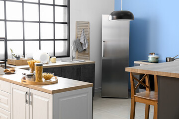 Interior of comfortable kitchen with stylish counters and utensils