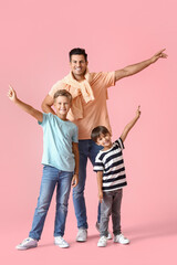 Happy man and his sons on color background