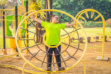woman with autistic or down syndrome playing at playground in park
