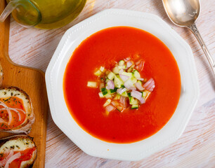 Traditional Andalusian cold soup gaspacho served with hot sandwiches