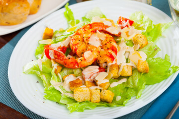 Caesar salad on plate at restaurant. High quality photo