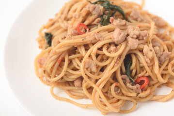Spicy stir fried Spaghetti with chicken and basil leaf