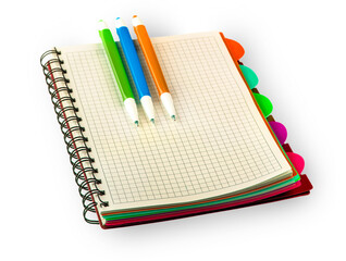 red Diary notebook and colored pens isolated on white background.