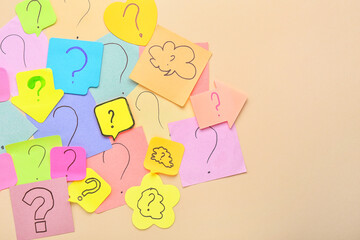 Paper sticks with question marks on beige background