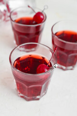 Glasses of tasty Manhattan cocktail on light background, closeup