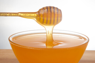 fresh fragrant honey drips from a spoon into a plate. organic vitamin nutrition. dessert food