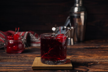 Glass of tasty Manhattan cocktail on table