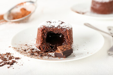 Plate with tasty lava cake fondant on light background, closeup