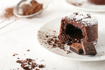 Plate with tasty lava cake fondant on light background, closeup