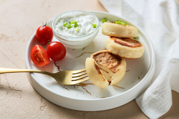 Plate with tasty cottage cheese pancakes, sauce and tomato on color background, closeup