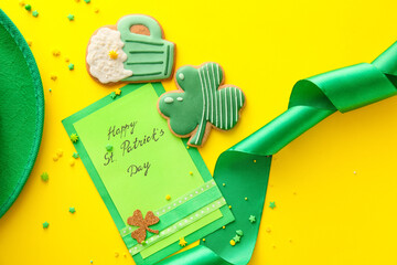 Composition with tasty gingerbread cookies for St. Patrick's Day celebration on yellow background
