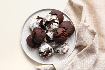 Plate with tasty brownie cookies on light background