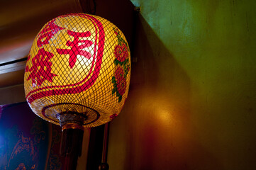 Asian Chinese yellow red traditional lattern hanging on the wall for Chinese New Year celebration