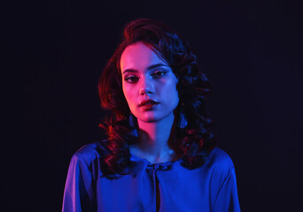 Toned portrait of young woman on dark background