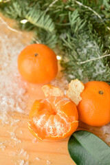 Fototapeta na wymiar Tasty tangerines and snow on wooden background