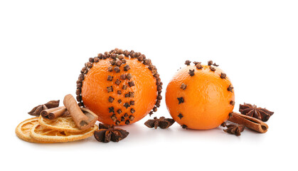 Handmade Christmas decoration made of tangerines with cloves and cinnamon on white background