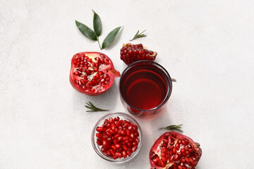 Glass of delicious pomegranate juice and fresh fruits on white background