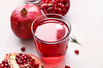 Glass of delicious pomegranate juice and fresh fruits on white background