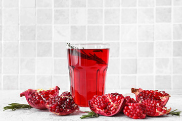 Glass of delicious pomegranate juice on table
