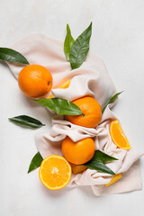 Fresh juicy oranges with leaves on white background