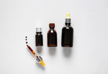 Different bottles with iodine and pipette on grey background