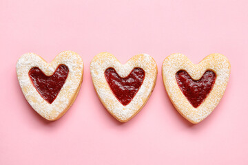 Obraz na płótnie Canvas Tasty cookies in heart shape on pink background