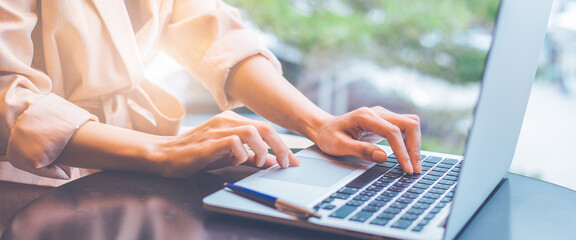 Business woman working with a laptop computer in the office.
