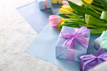Composition with gift boxes and flowers for International Women's Day celebration on light...