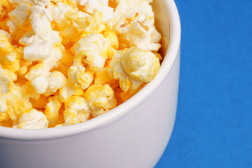 bowl of popcorn against blue background