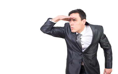 Attentive man keeping hand on forehead and looking at distance