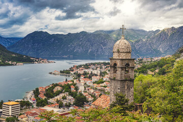 Naklejka na ściany i meble Famous view of the bell tower and Kotor old town, surrounded by mountains and waters of Kotor bay
