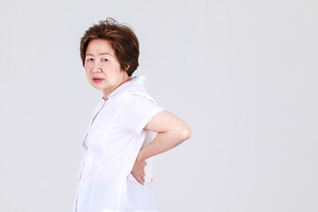 Elderly aunt stand tilt and twist with hands on waist as disappointed on body disease and tired of...