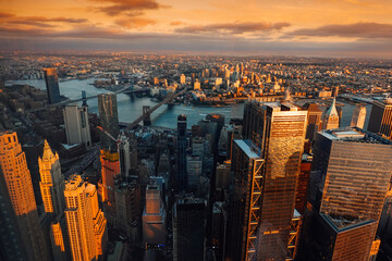 Sunset in New York, view from above. Amazing sun light over Manhattan and Hudson river during a sunset, images taken from the highest building in the city. Impressive architecture. Landmark of America